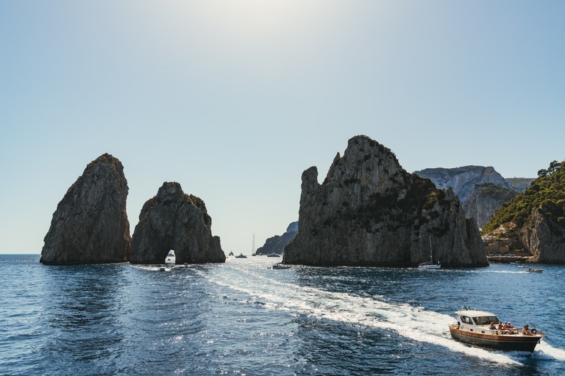 This Dreamy Capri Boutique Hotel Boasts Breathtaking Faraglioni Views | Hotel La Tosca entrance | Hotel La Tosca ruby suite | Hotel La Tosca bathroom | Hotel La Tosca patterned bedroom | Hotel La Tosca blue bedroom | Hotel La Tosca restaurant | Hotel La Tosca balcony