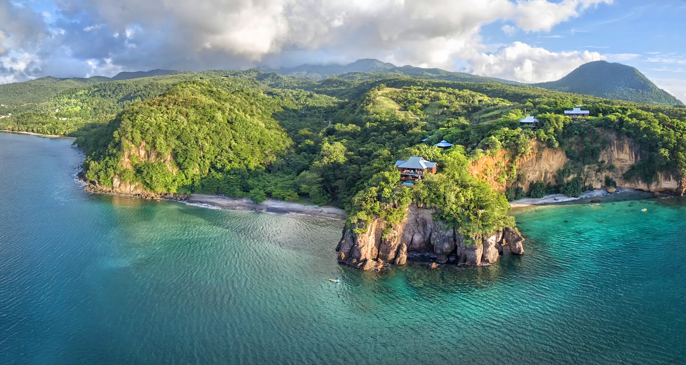 Hotel Review: Secret Bay Relais & Châteaux (Dominica) | Secret Bay Relais & Châteaux bay view | Secret Bay Relais & Châteaux treehouses | Secret Bay Relais & Châteaux bedroom | Secret Bay Relais & Châteaux seating | Secret Bay Relais & Châteaux restaurant | Secret Bay Relais & Châteaux outdoor pool