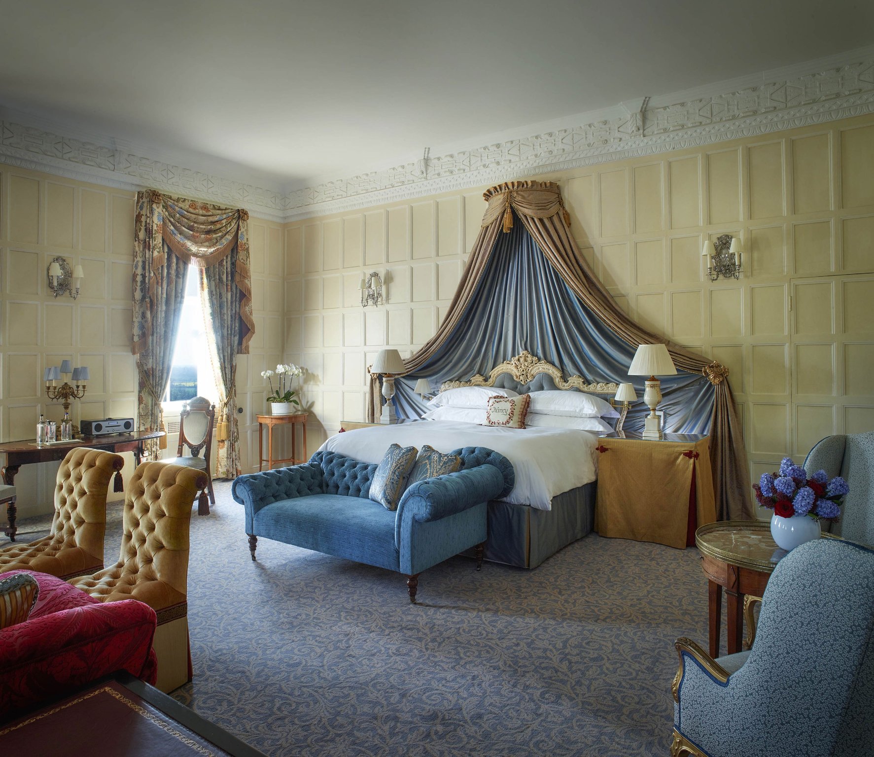 This Boutique Hotel in Berkshire Is the Perfect British Escape | Cliveden House entrance | Cliveden House indoor pool & spa | Cliveden House dining room | Cliveden House orange bedroom | Cliveden House blue bedroom | Cliveden House grounds