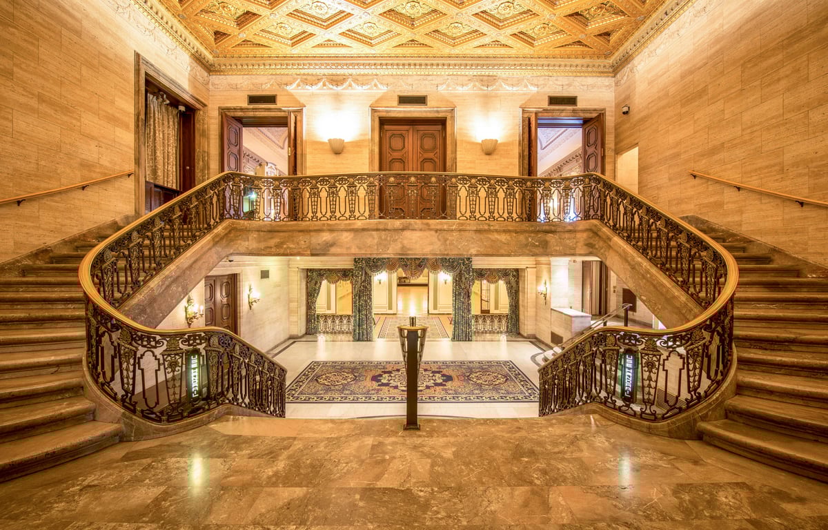 This 20th-Century Landmark Hotel in Delaware Is a Glimpse Into the Gilded Age | Hotel Du Pont exterior | Hotel Du Pont double staircase | Hotel Du Pont ballroom | Hotel Du Pont bedroom | Hotel Du Pont restaurant | Hotel Du Pont lobby