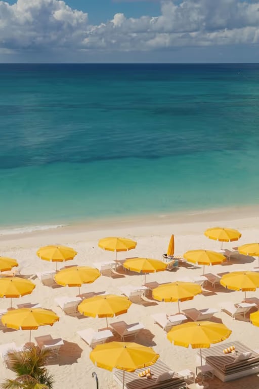 Grand Cayman's First All-suite Boutique Hotel is a Chic, Sun-kissed Retreat on Seven Mile Beach | Palm Heights beach yellow umbrellas | Palm Heights interior Grand Cayman | Palm Heights suite Grand Cayman | Palm Heights Tillies restaurant Grand Cayman | Palm Heights Coconut Club Grand Cayman