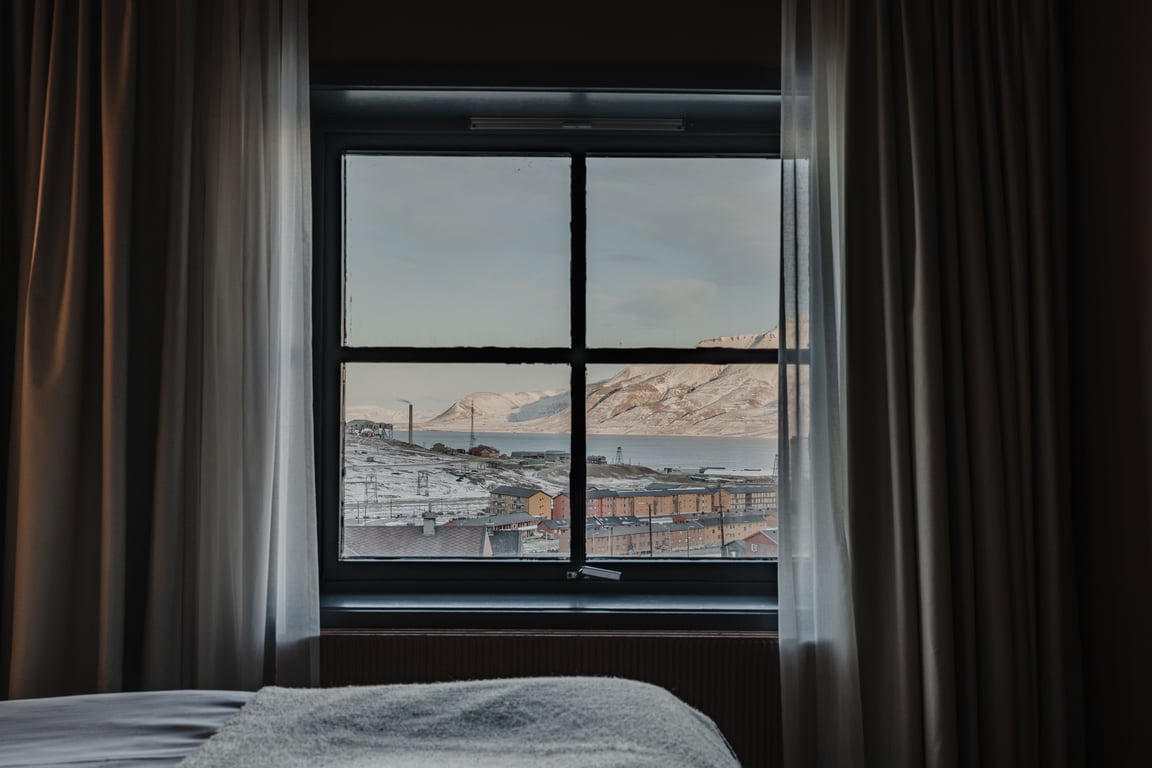 This Scandi-Chic Arctic Outpost Is One Of The World’s Northernmost Boutique Hotels | Funken Lodge hotel lounge | Funken Lodge hotel restaurant | Funken Lodge suite bedroom | Funken Lodge changing room | Funken Lodge suite desk
