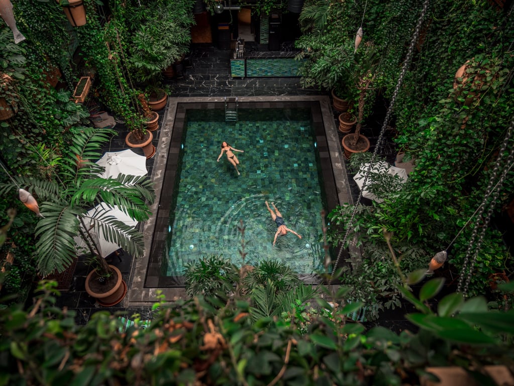 This Bohemian Hotel in Copenhagen Offers an Unexpected Jungle Retreat | Manon Les Suites outdoor pool | Manon Les Suites outdoor swing | Manon Les Suites jungle pool