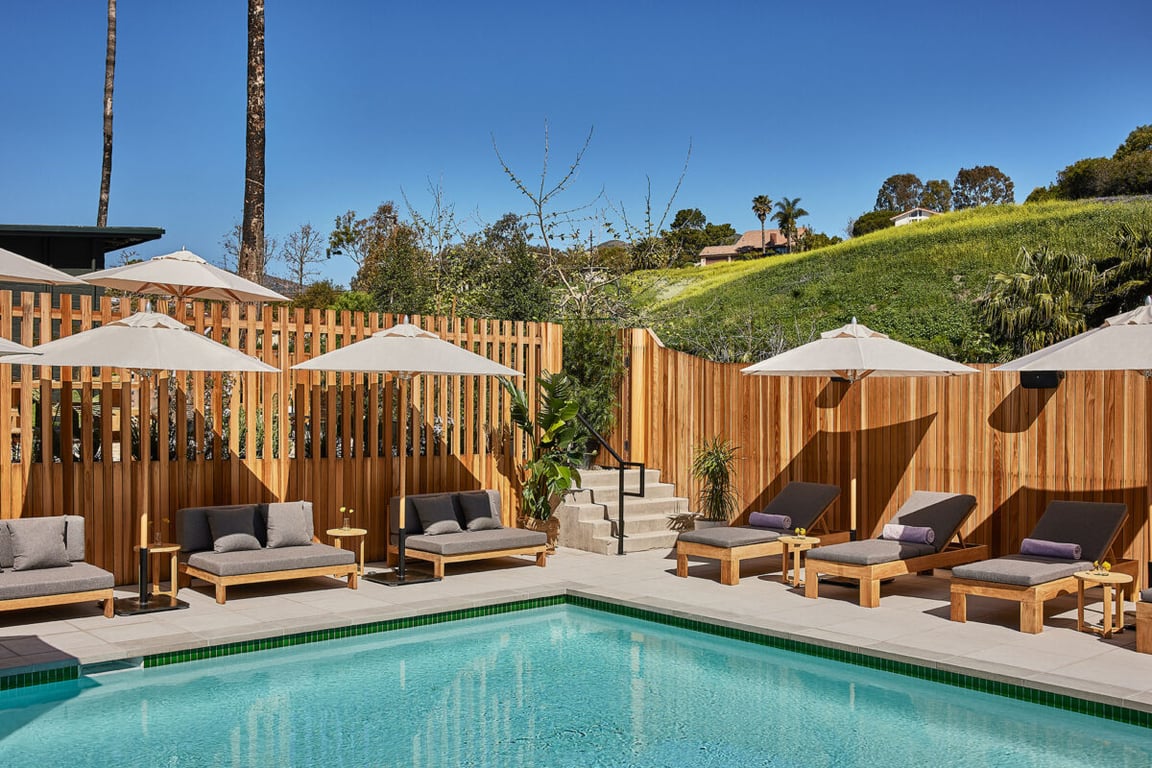 The Boutique Hotel in Malibu Where Bob Dylan Once Stayed | Hotel June Malibu sign | Hotel June Malibu suite kitchen | Hotel June Malibu bedroom suite | Hotel June Malibu outdoor pool | Hotel June Malibu suite green exteriors | Hotel June Malibu open style suite design