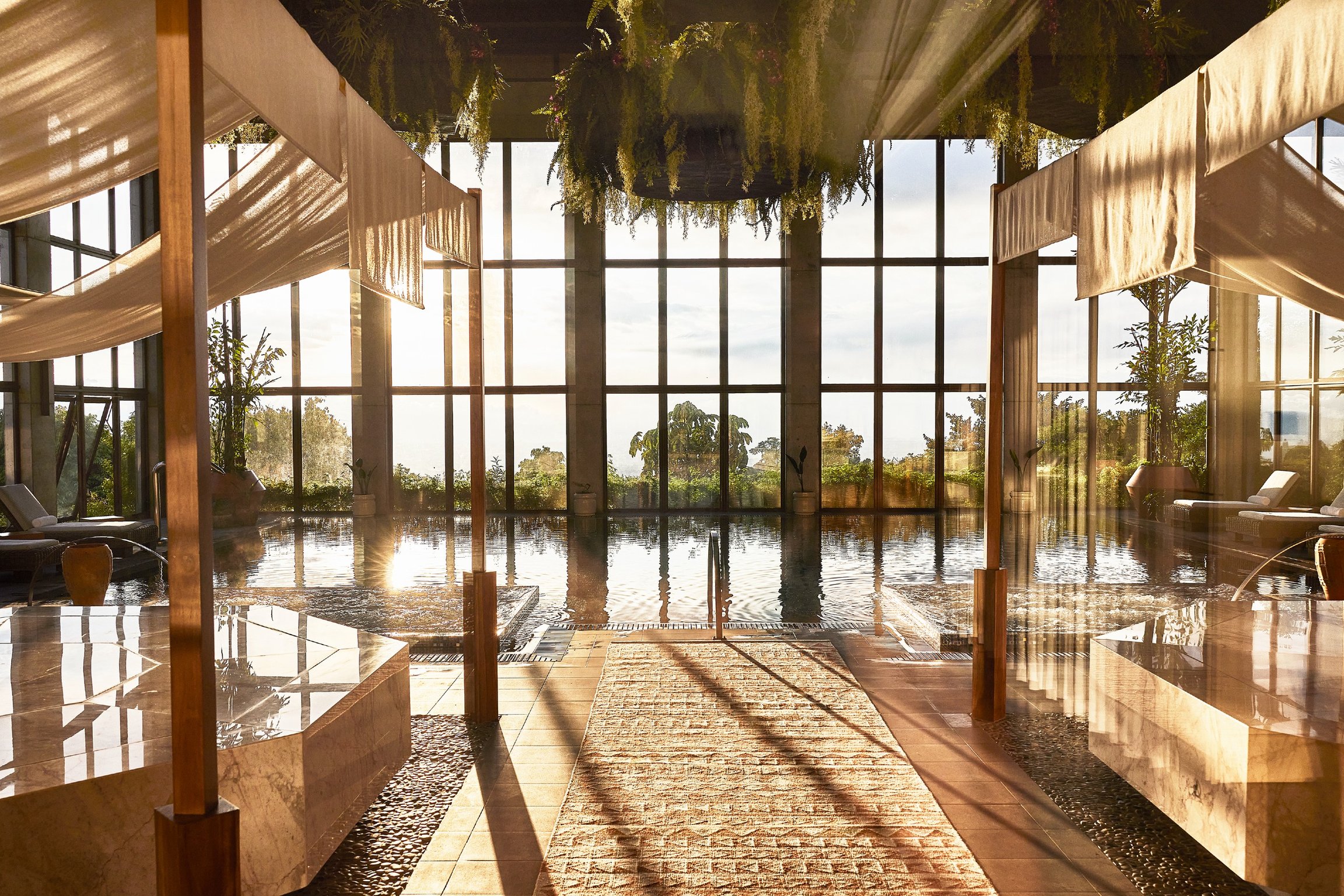 This Costa Rican Rainforest Hotel Is Worth the Trek | Hacienda AltaGracia aerial view | Hacienda AltaGracia outdoor lounge | Hacienda AltaGracia outdoor seating | Hacienda AltaGracia cabana seating | Hacienda AltaGracia cabana poolsode seating | Hacienda AltaGracia restaurant | Hacienda AltaGracia outdoor walkways | Hacienda AltaGracia greenhouse | Hacienda AltaGracia outdoor pool