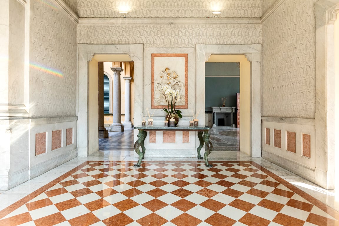 This Historic Villa in Lake Como Offers Some of the Best Views in Italy | Hotel Villa Cipressi exterior | Hotel Villa Cipressi exposed brick floor in suite | Hotel Villa Cipressi bedroom suite | Hotel Villa Cipressi outdoor fountain | Hotel Villa Cipressi lobby floor | Hotel Villa Cipressi suite balcony | Hotel Villa Cipressi Ocean entrance