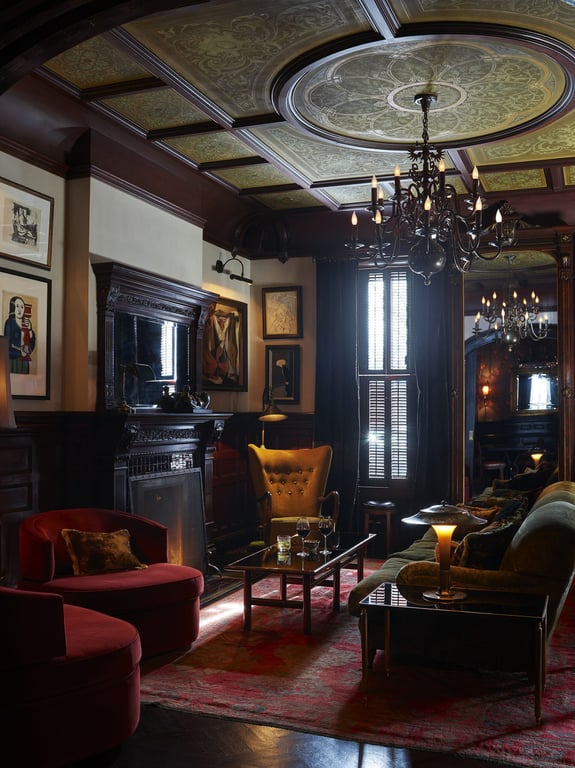 A Weekend at The Maker Hotel in Hudson, New York, Will Make You Want to Copy Every Little Design Detail | The Maker Hotel picture display | The Maker Hotel walkway arches | The Maker Hotel fireplace | The Maker Hotel bedroom | The Maker Hotel second bedroom suite | The Maker Hotel seating | The Maker Hotel restaurant
