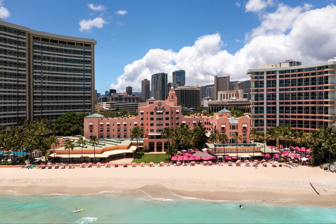 The Pink Palace of Waikiki Continues to Captivate Guests with Royal History and Modern Luxury | Pink Palace exterior | Pink Palace decor | Pink Palace outdoor pool | Pink Palace bedroom suite | Pink Palace private beach | Pink Palace outdoor activities | Pink Palace outdoor restaurant