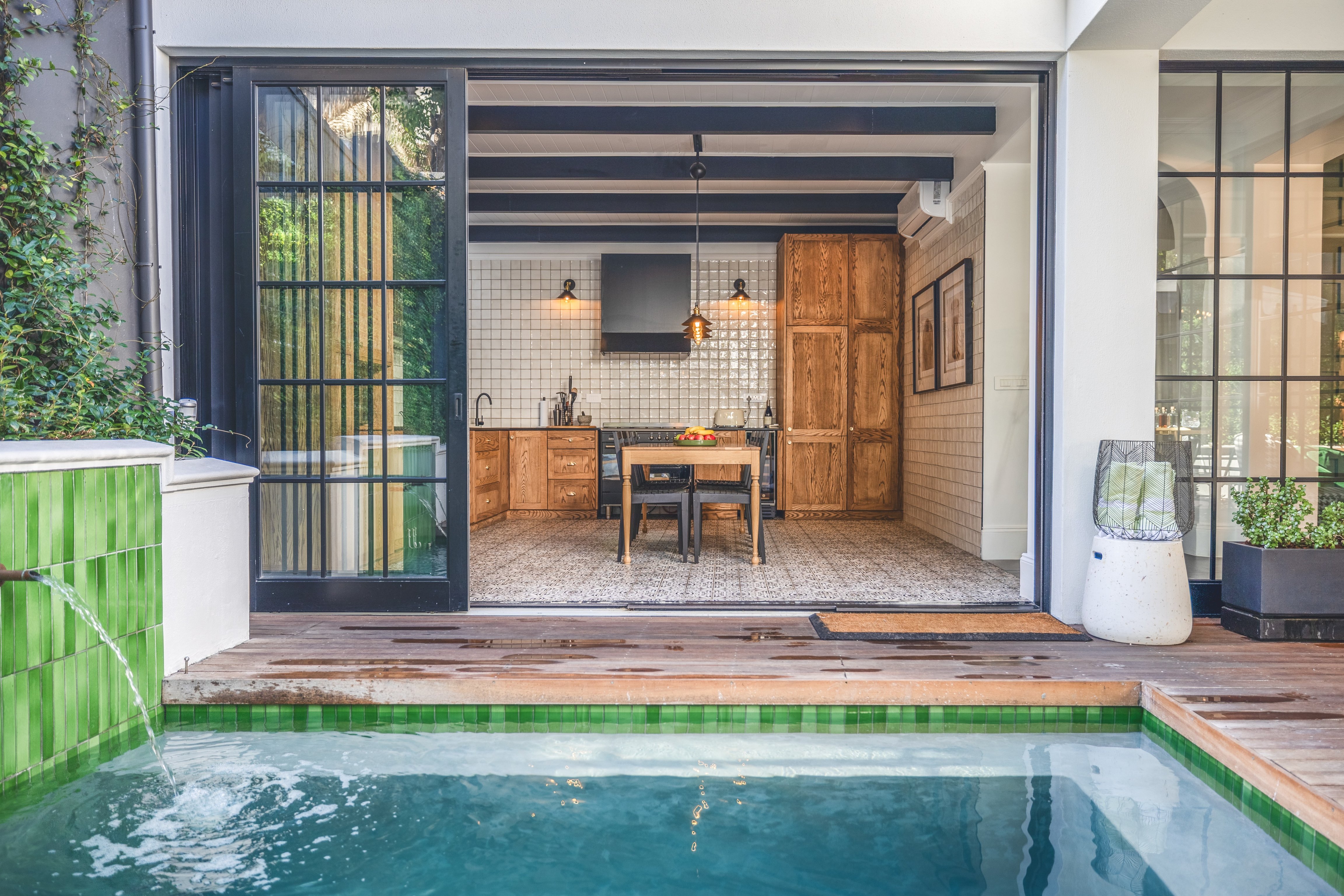 Private plunge pool opening onto a kitchen suite with steel-frame doors at Cape Cadogan.