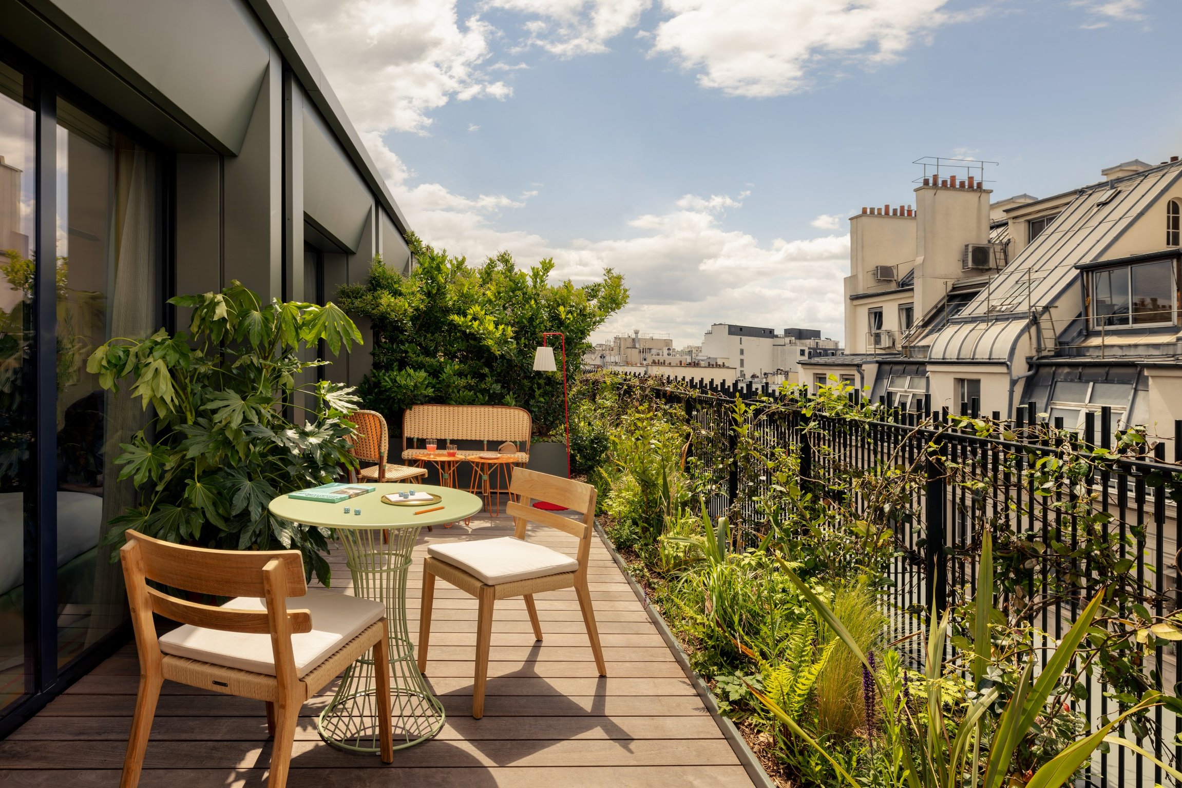 A Fantastical Stay and Secret Garden Await at This Boutique Hotel in Paris | La Fantaisie Paris suite seating and decor | La Fantaisie Paris golden poppy interior | La Fantaisie Paris junior suite with terrace | La Fantaisie Paris bar | La Fantaisie Paris la Cafe | La Fantaisie Paris spa