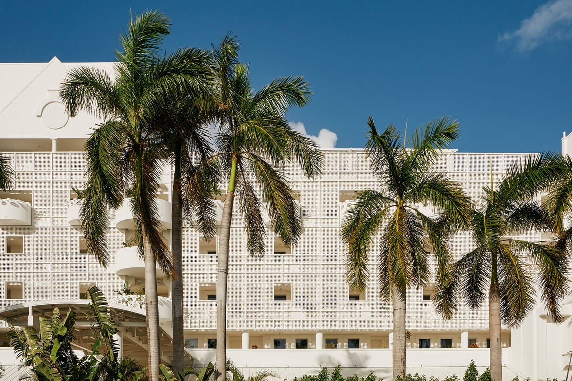 Grand Cayman's First All-suite Boutique Hotel is a Chic, Sun-kissed Retreat on Seven Mile Beach | Palm Heights beach yellow umbrellas | Palm Heights interior Grand Cayman | Palm Heights suite Grand Cayman | Palm Heights Tillies restaurant Grand Cayman | Palm Heights Coconut Club Grand Cayman