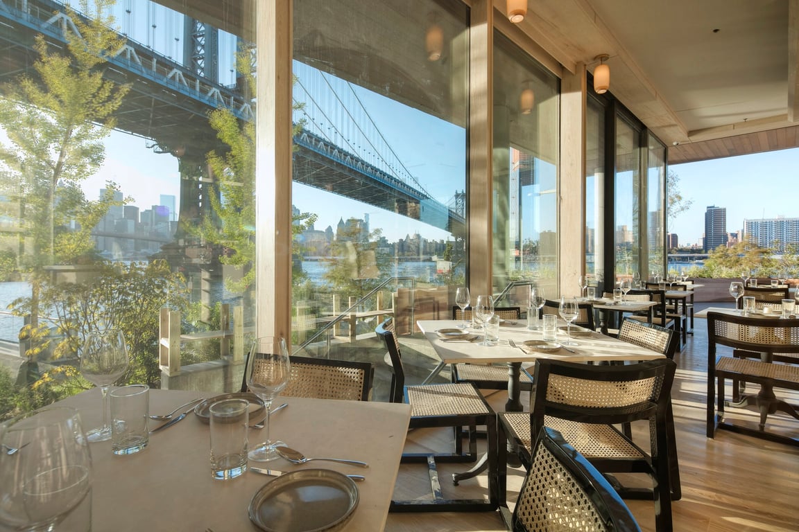 This Waterfront Restaurant in Dumbo, Brooklyn, Boasts Unparalleled Views of the Manhattan Cityscape | Celestine in Dumbo NYC outdoor seating | Brooklyn Bridge | Celestine in Dumbo NYC signature dish | Celestine in Dumbo NYC signature cocktail | Celestine in Dumbo NYC dish