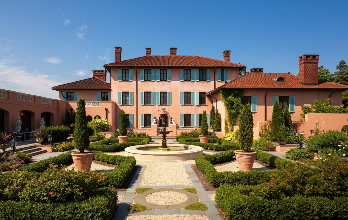 Glenmere Mansion Exudes Old-World European Glamour In the Lower Hudson Valley | Glenmere Mansion entrance | Glenmere Mansion bedroom suite | Glenmere Mansion lobby | Glenmere Mansion seating area | Glenmere Mansion restaurant | Glenmere Mansion restaurant seating | Glenmere Mansion outdoor seating