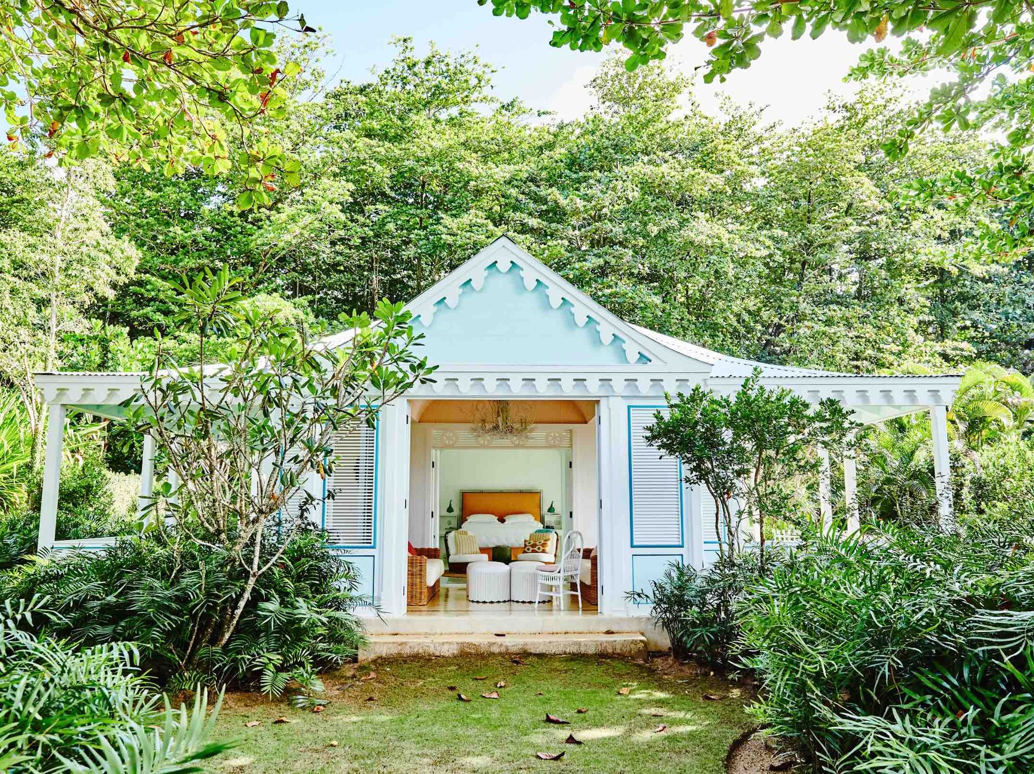 This Charming Caribbean Boutique Hotel Is One of the Region’s Best-Kept Secrets | Playa Grande Beach Club exterior | Playa Grande Beach Club hammock on balcony | Playa Grande Beach Club dining | Playa Grande Beach Club garden patio