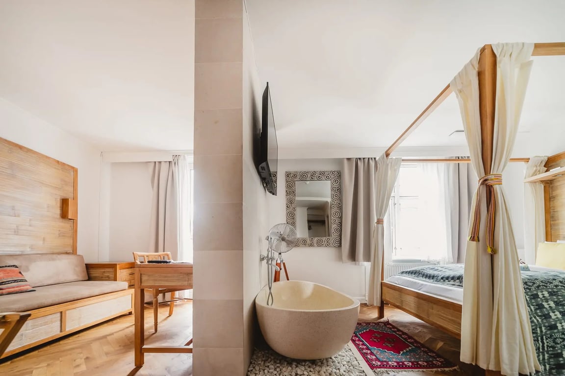 Hygge Meets Balinese Design at This Sustainably-Minded Copenhagen Stay | Axel Guldsmeden hotel exterior | Axel Guldsmeden restaurant seating | Axel Guldsmeden restaurant dining | Axel Guldsmeden bedroom suite | Axel Guldsmeden spa