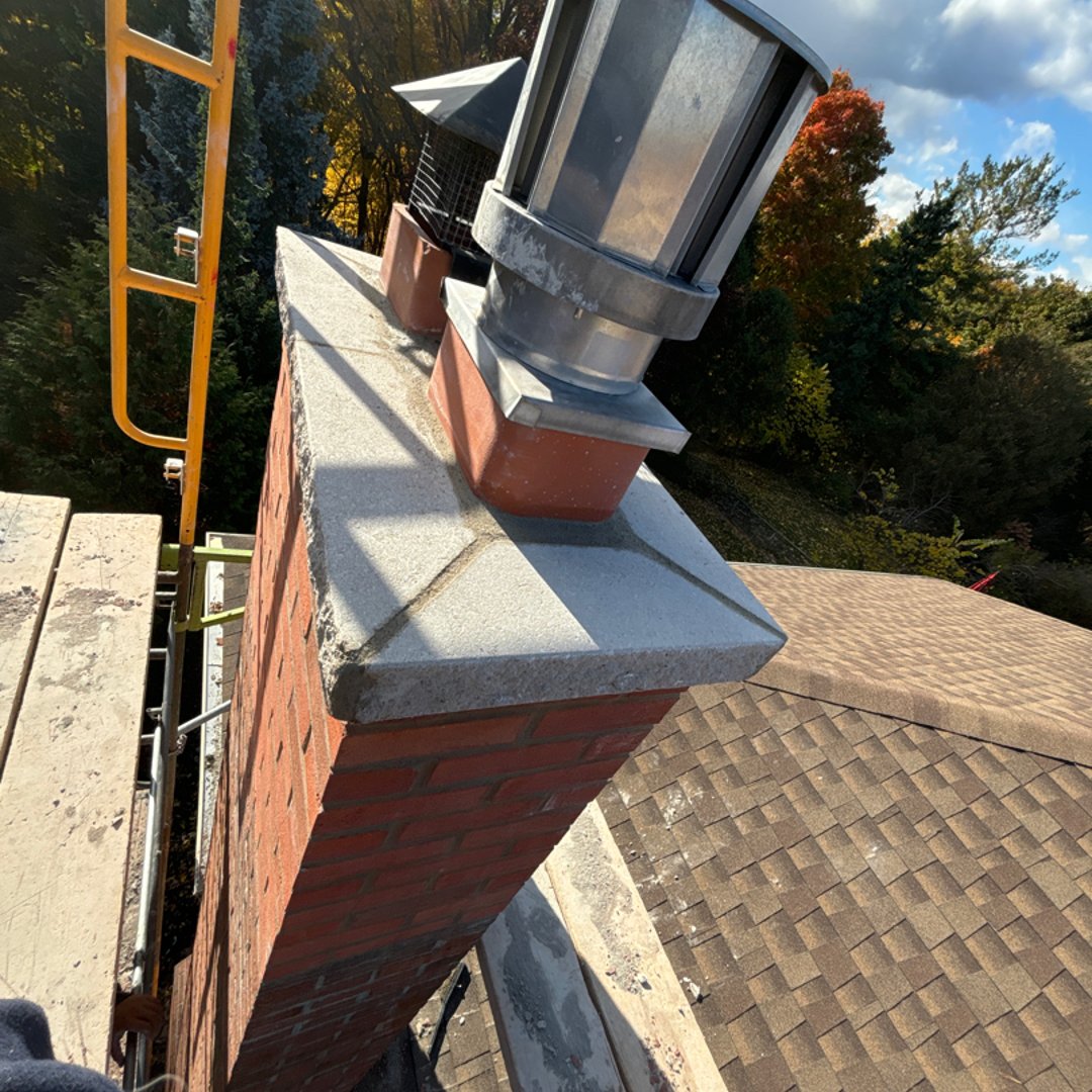 Chimney cap installation service showing protective cap being installed on residential chimney