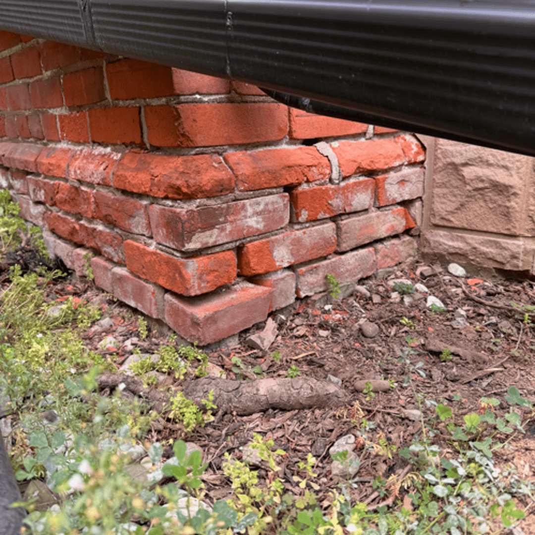Close-up of crumbling mortar joints showing deep deterioration