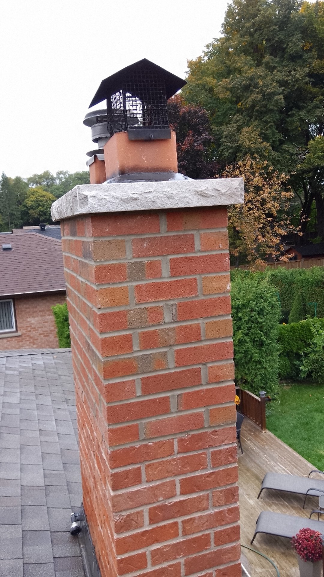 Chimney rebuilding service in progress showing masonry contractors rebuilding damaged chimney structure