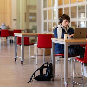 Student typing on laptop