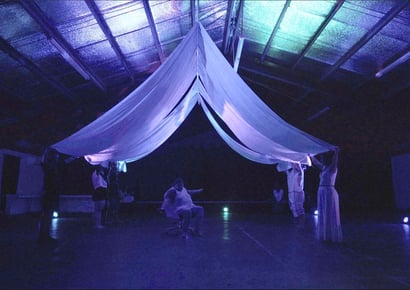 purple and blue photo with a tent like structure in the middle