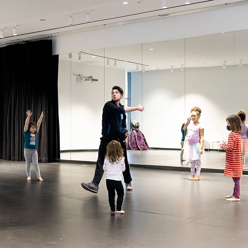 Matthew Cumbie, a visiting assistant professor of theater and dance, leads children in a joyful dance workshop during Joy to the Ville at the Paul J. Schupf Arts Center