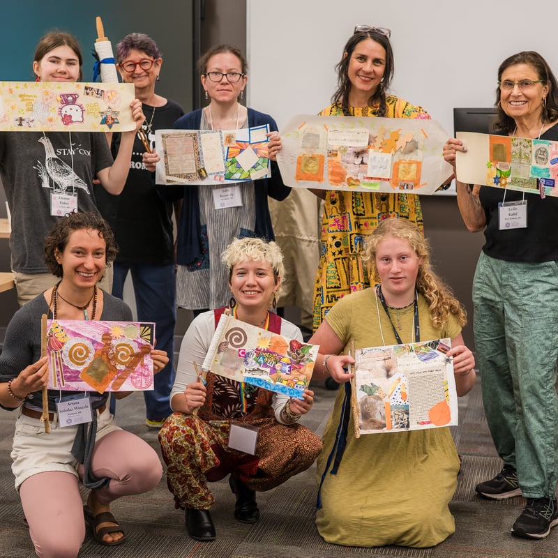 A group of people holding up craft collages