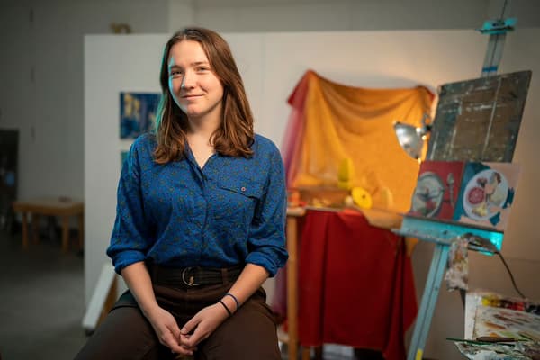 A woman seated for a portrait.