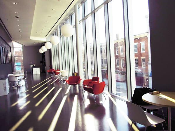 The upper floor of the Paul J. Schupf Art center, bathed in light coming in from floor to ceiling windows.