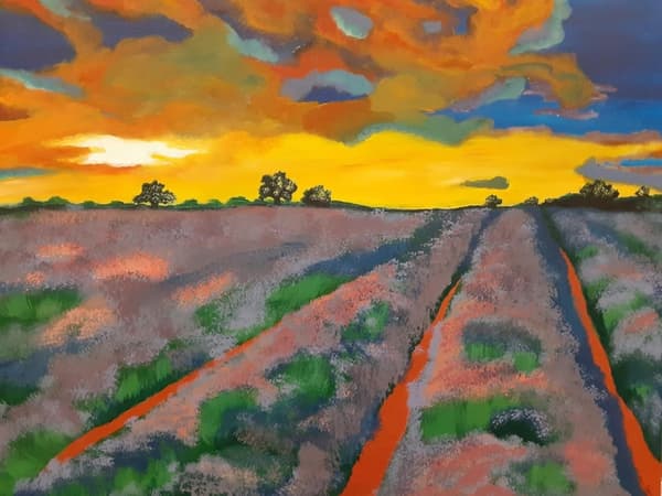 In a student-made artwork, a field of green and gray is illumincated by a sunset