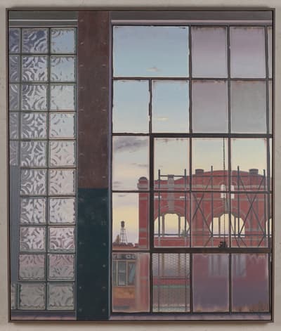 A window with frosted glass on the left and clear panes on the right, showing a red brick building and sky.