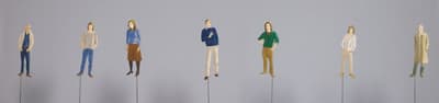 A detail of a piece by Alex Katz that depicts seven small portraits of people attached to metal wires.