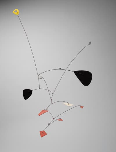 Kinetic sculpture with metal rods and colorful abstract shapes.