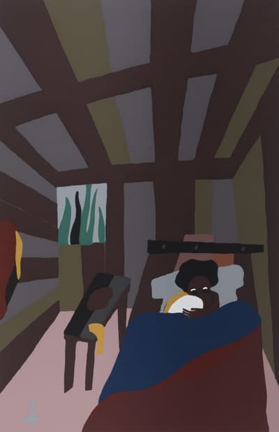 A woman in bed, holding what appears to be a small child in her arms.