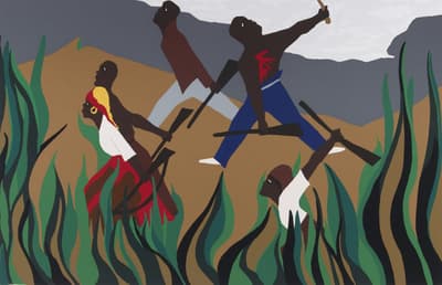 A group of individuals running through long grass with guns.