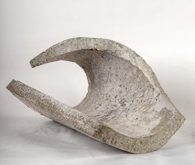 Curved concrete sculpture, resembling a crashing wave.