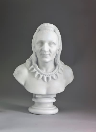 A marble bust of a man wearing a necklace.