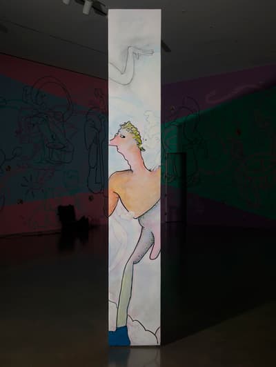 Art gallery with colorful abstract murals on walls and a polished concrete floor.