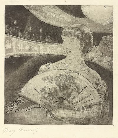 A young woman sitting at the opera holding a fan in her hands which she rests in her lap.