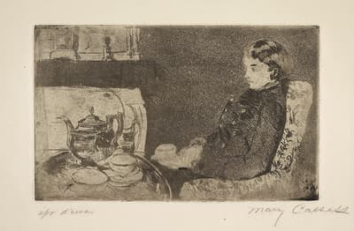 A woman seated in a large arm chair in front of a table covered with two saucers and a large tea kettle.