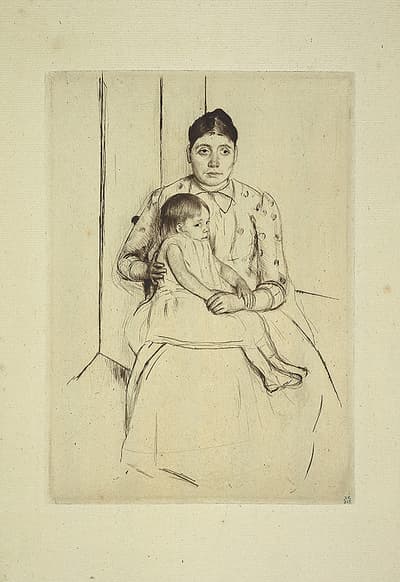 A woman in a spotted dress sitting with a child across her lap.