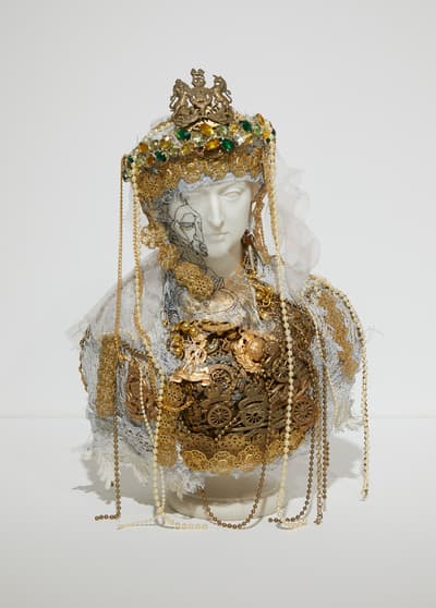 An elaborately adorned mannequin head.