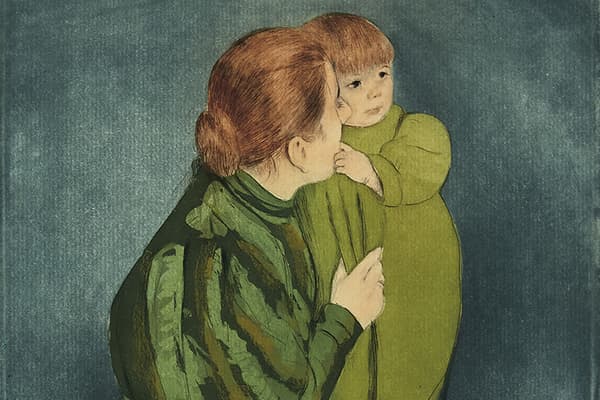 Mother in a green dress holding a child in an olive outfit, set against a blue background.