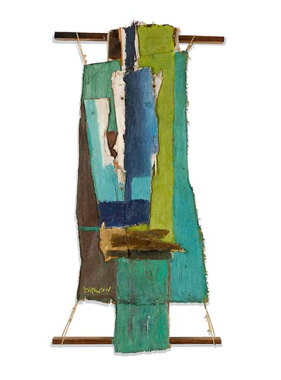 A wood scrap painted in shades of green, blue and white, held up by wood batter, bolts, and string.