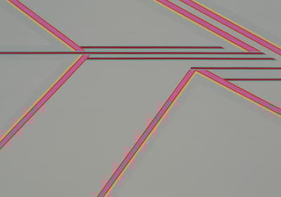 Non figurative artwork of bright pink geometric lines atop a gray background.