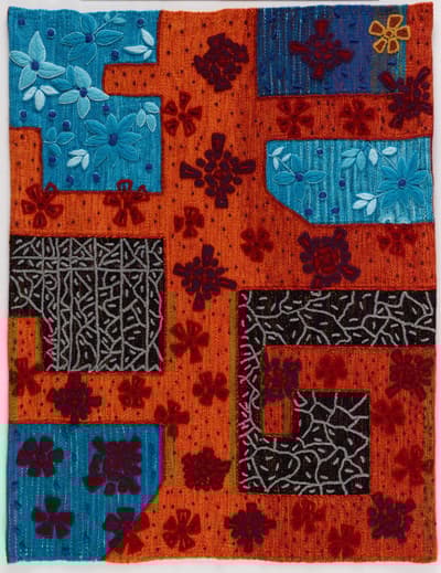 Orange and patterned textile with gray and blue geometric sections overlaid.