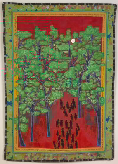A colorful quilt depicting green trees against a red background, with black silhouetted figures and multicolored stars in the border.