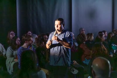 Tongva educator and musician Lazaro Arvizu, Jr. playing an instrument at a performance