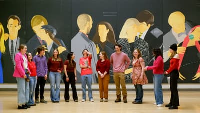 Student singing group in front of large scale painting by Alex Katz