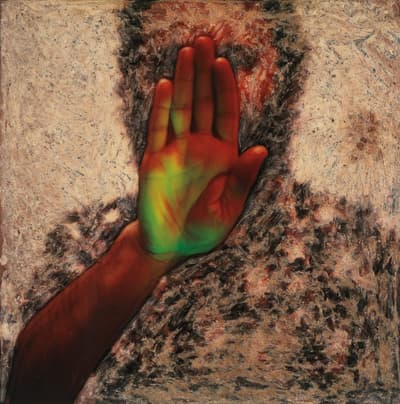 A colorful hand with red and green tones against a textured brown and beige background.