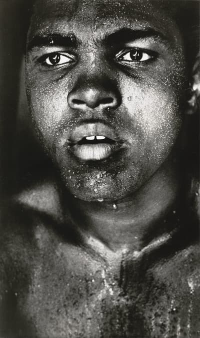 Close-up black and white portrait of a person with droplets of water on their face.